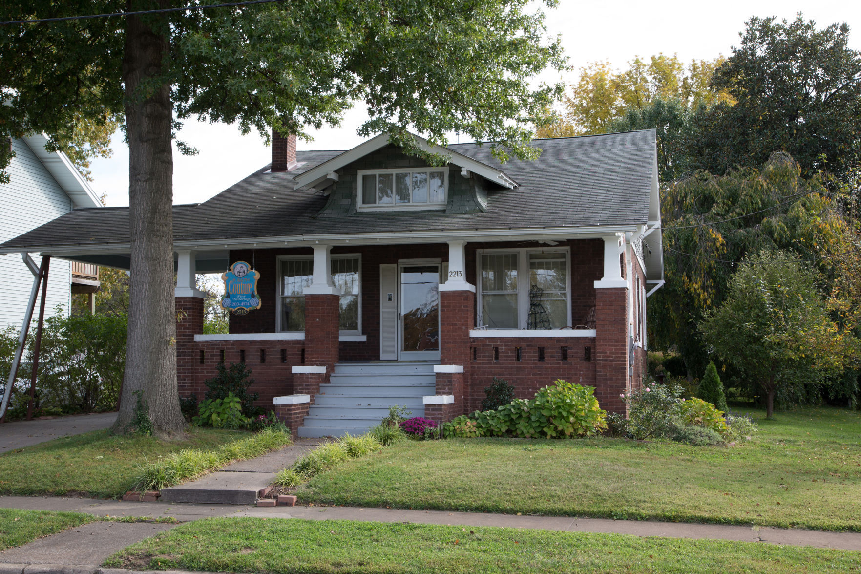 Pulling into the driveway of P. Rath Couture, the neat-as-a-pin home stands before you with tall windows and a wide stairway leading up to the front door.